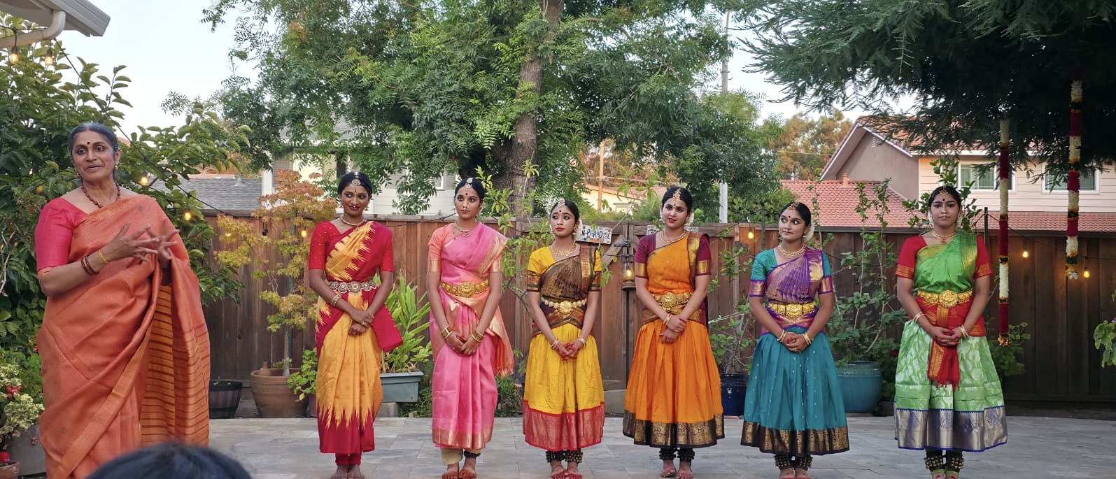 Nrityananda teacher and students in costume outdoors